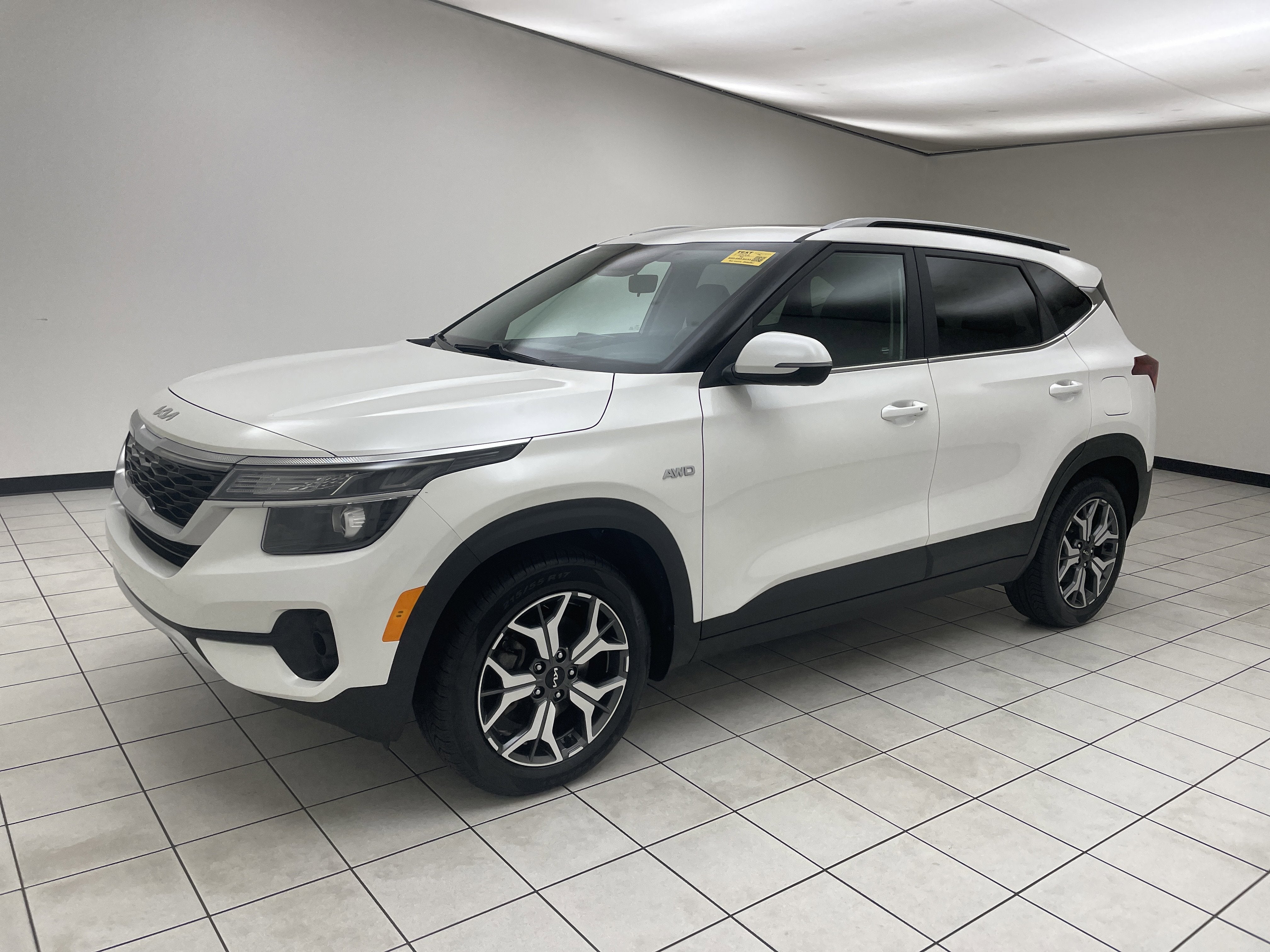 2023 Kia Seltos EX in Snow White Pearl — front three-quarter view